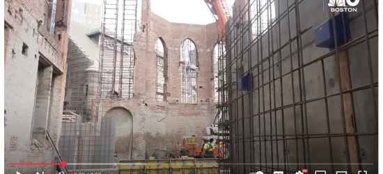 screenshot of a youtube of an NBC report showing a church being turned into condos, there are brick walls with church window arches, the rest is knocked down into rubble https://www.youtube.com/watch?v=D50hYNXru8k
